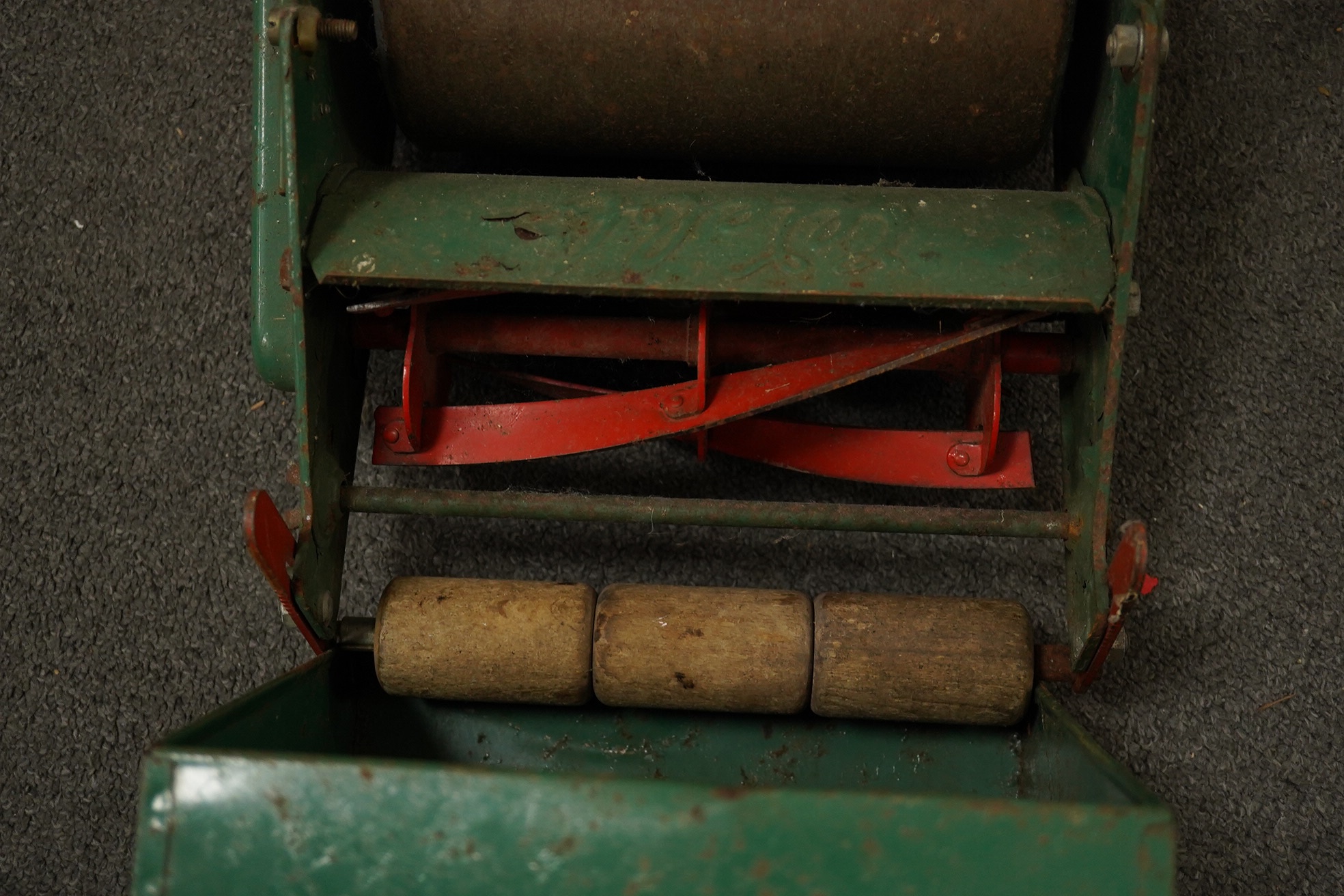 A late 1950s child's Webb push along scale model lawn mower, with Webb transfers to the grass box and side of the body and rubber handles, 63cm high. Condition - fair, some surface rust and general age related damage and